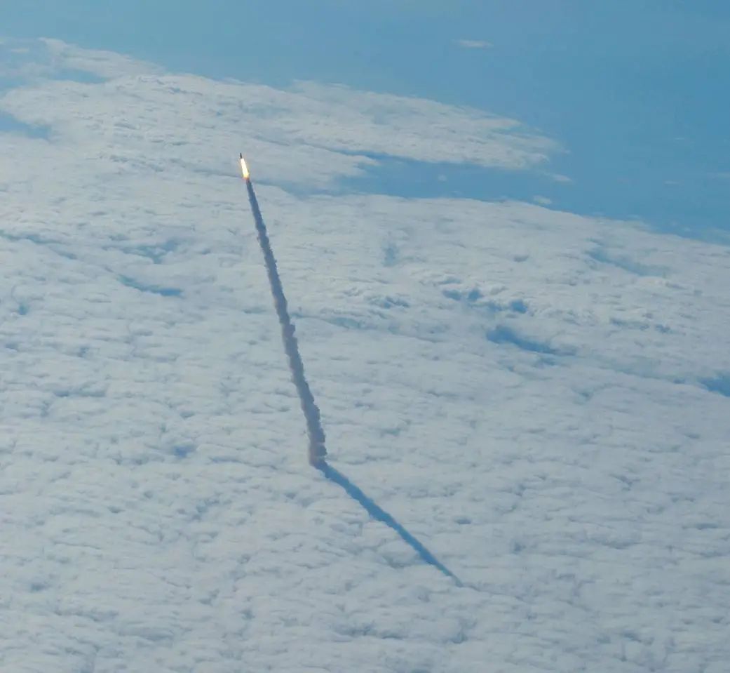 The Space Shuttle breaking through the cloud layer.